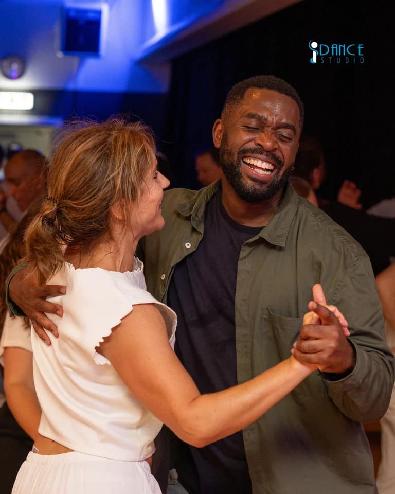 A couple laughing together during El Grande White Party.